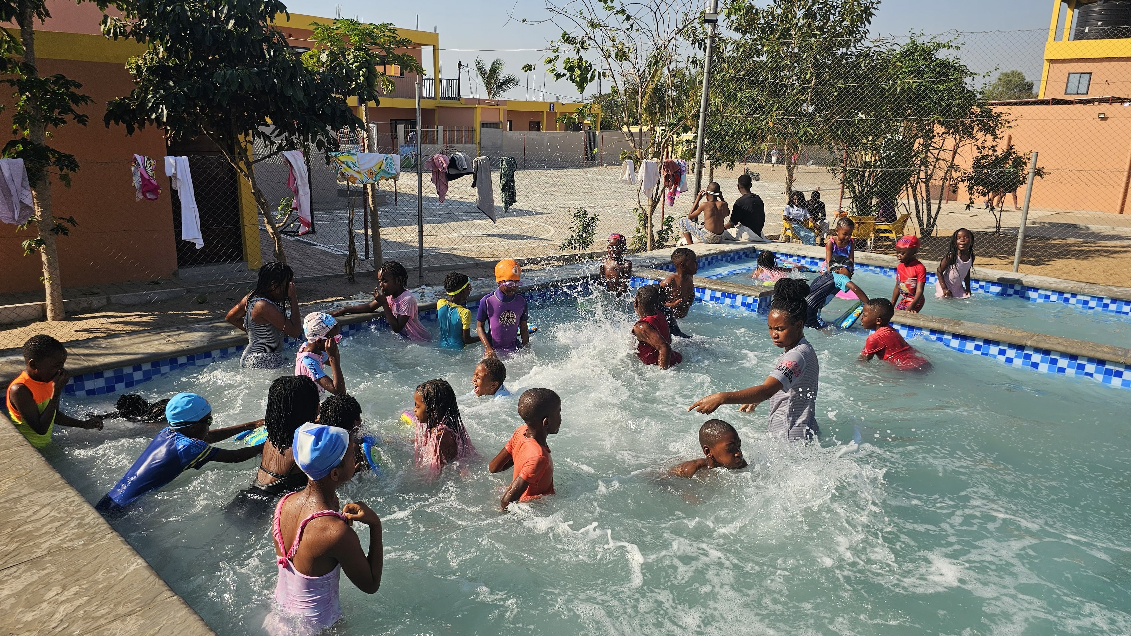 MGIS learners enjoying a swimming activity in the campus pool