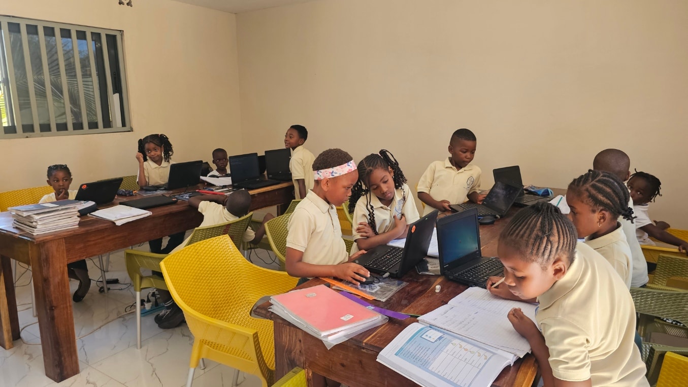 MGIS Grade 1 and 2 students working on laptops and notebooks in the computer classroom