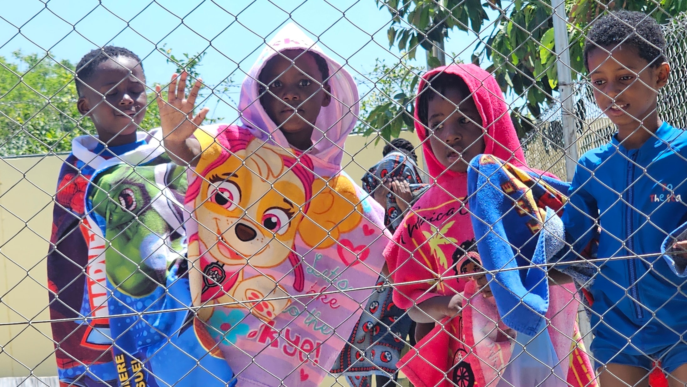 MGIS crèche children in colourful towels after swimming lesson